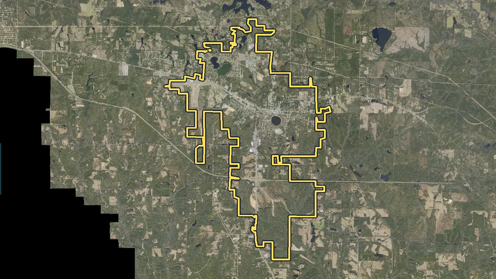 Aerial photo of DeFuniak Springs, Florida, with the community's outline drawn on it