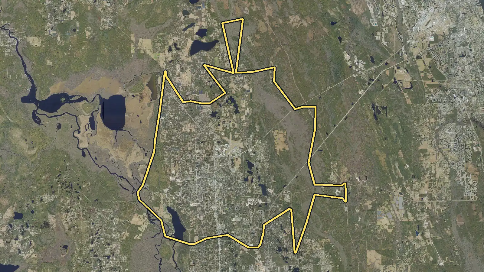Aerial photo of DeLand, Florida, with the community's outline drawn on it