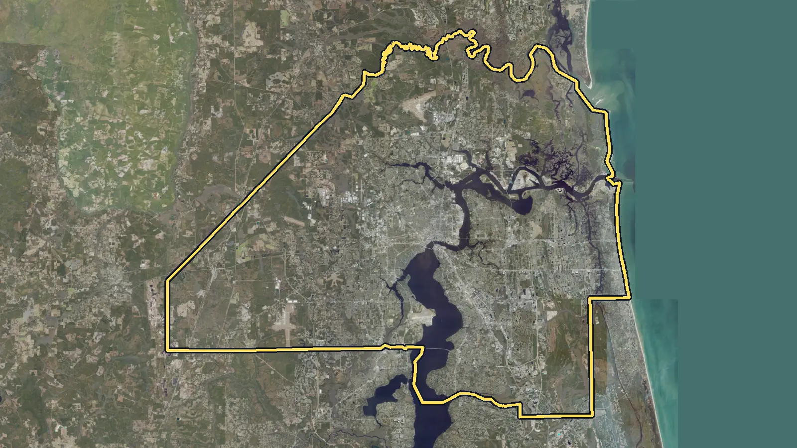 Aerial photo of Duval County, Florida, with the county's outline drawn on it