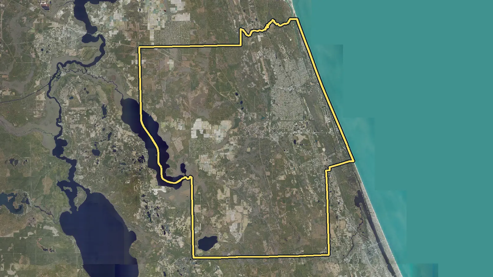 Aerial photo of Flagler County, Florida, with the county's outline drawn on it