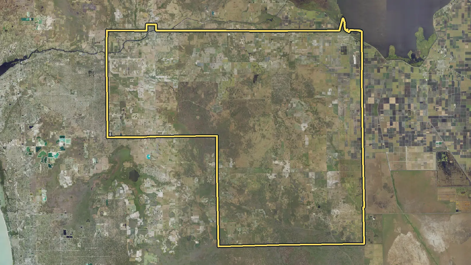 Aerial photo of Hendry County, Florida, with the county's outline drawn on it