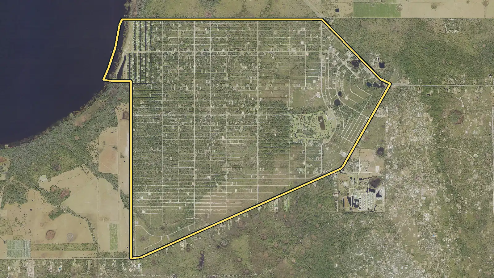 Aerial photo of Indian Lake Estates, Florida, with the community's outline drawn on it