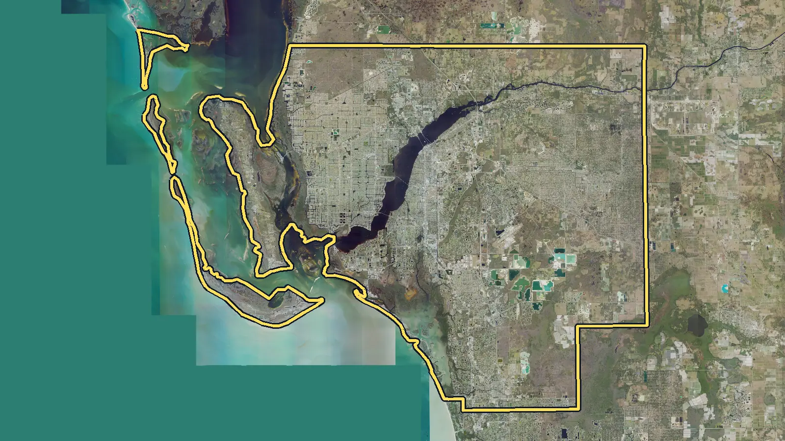 Aerial photo of Lee County, Florida, with the county's outline drawn on it