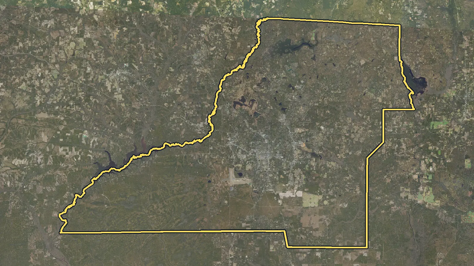 Aerial photo of Leon County, Florida, with the county's outline drawn on it