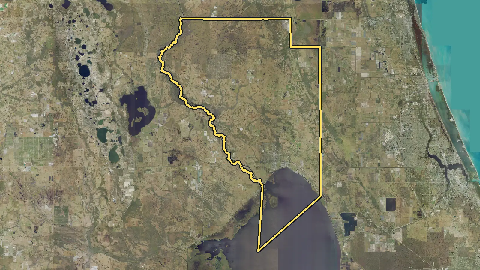 Aerial photo of Okeechobee County, Florida, with the county's outline drawn on it