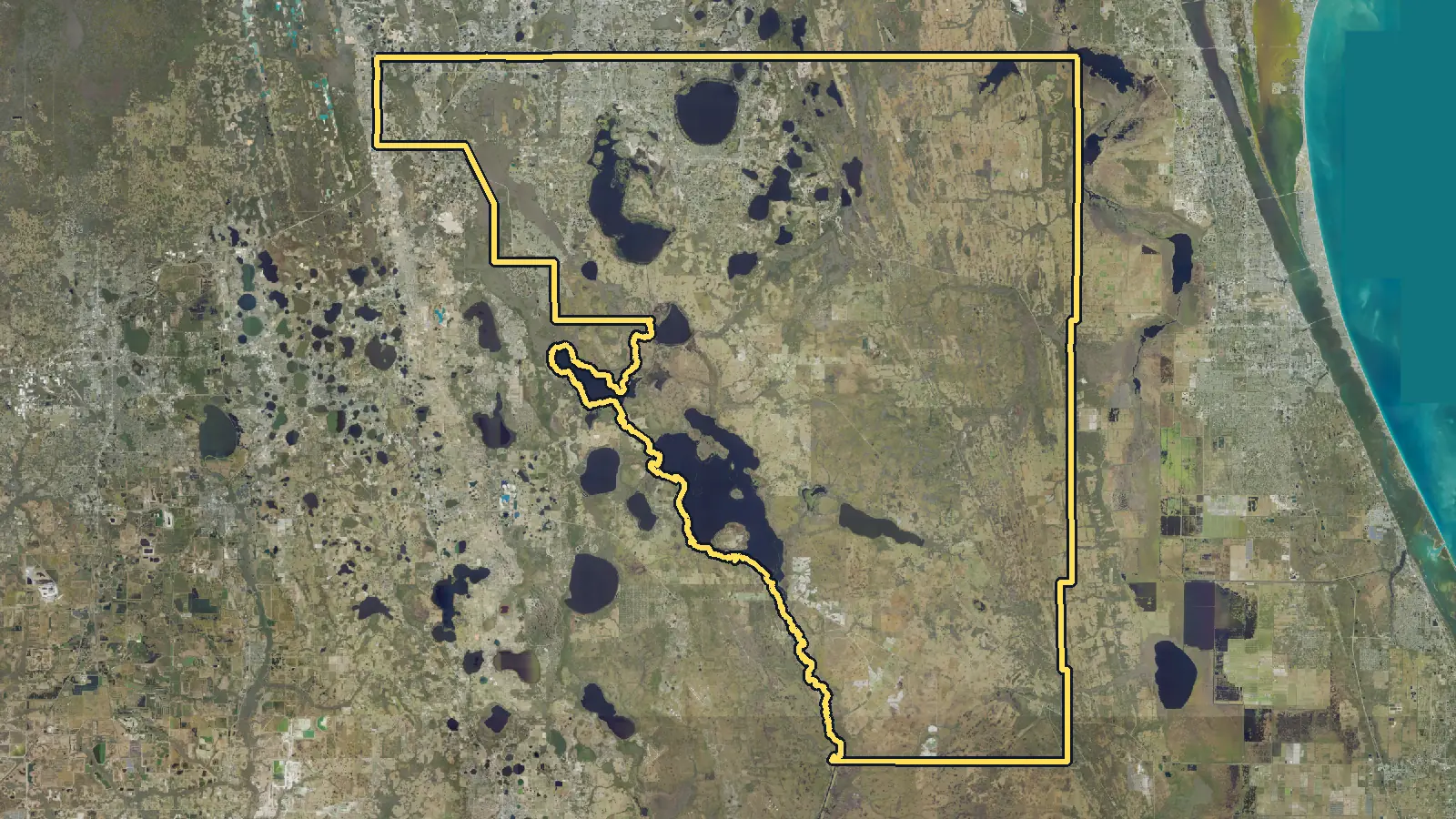 Aerial photo of Osceola County, Florida, with the county's outline drawn on it