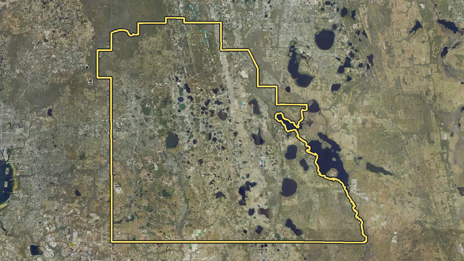 Aerial photo of Polk County, Florida, with the county's outline drawn on it
