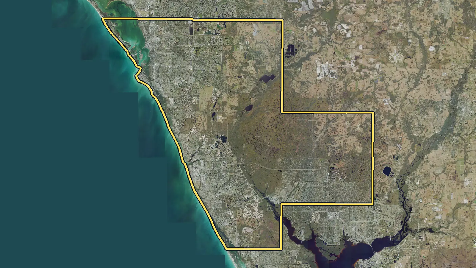 Aerial photo of Sarasota County, Florida, with the county's outline drawn on it