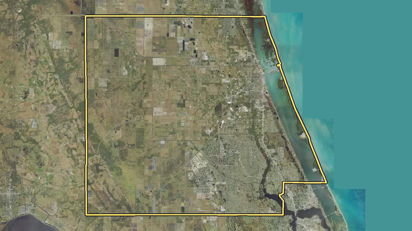 Aerial photo of St. Lucie County, Florida, with the county's outline drawn on it