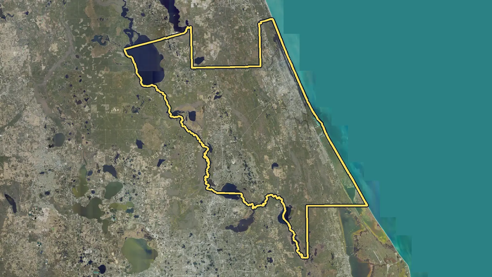 Aerial photo of Volusia County, Florida, with the county's outline drawn on it